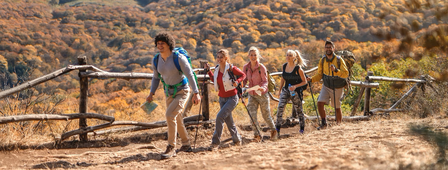 An image of a group of happy people on their way to a hiking.